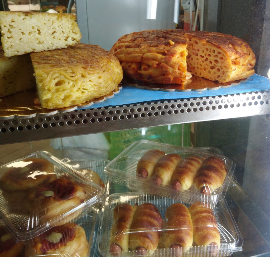 Two types of Frittatina displayed on the top shelf of counter
