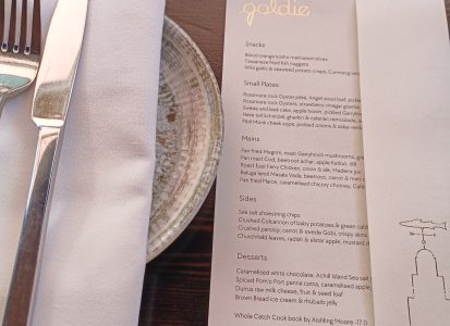 Overview of Goldie Menu and dinner place setting