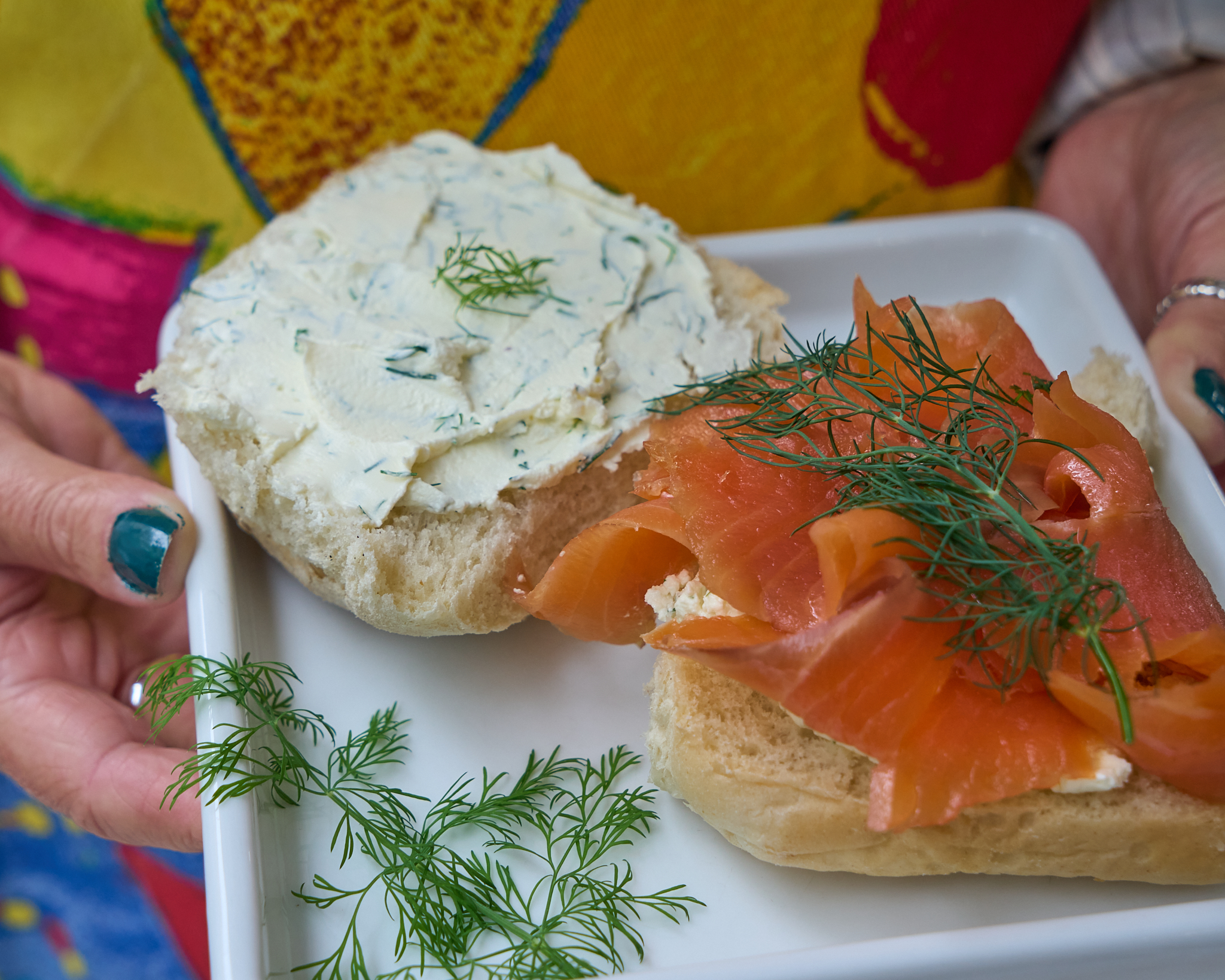 Close up of South East Sunshine Blaa on square plate held by hand